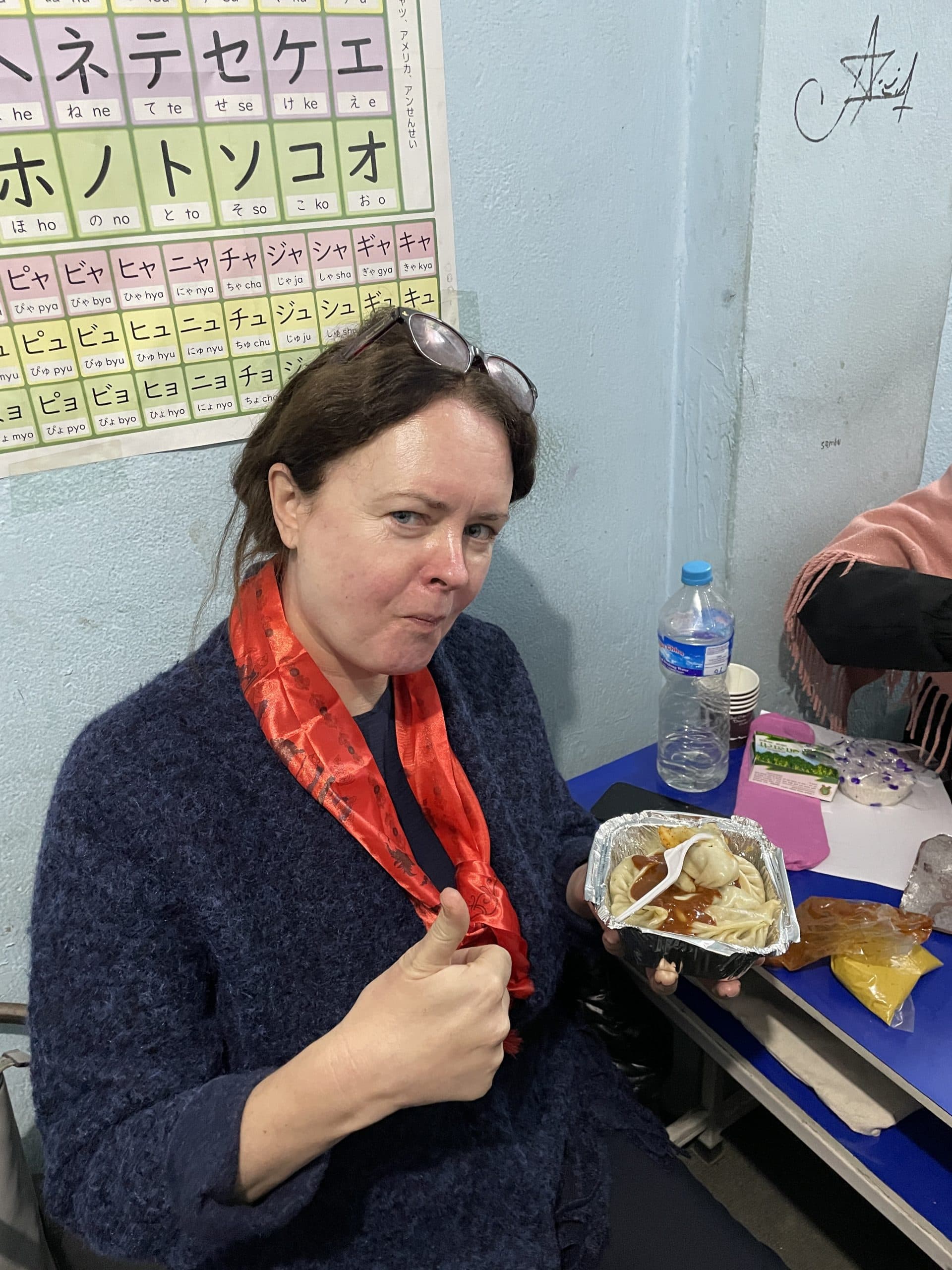 A volunteer holding a plate of food during a break in a programme day